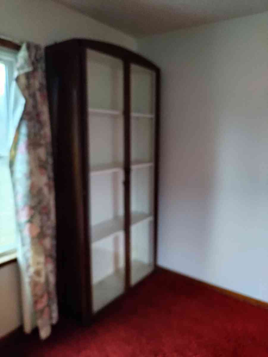 two very tall vanities or display cases