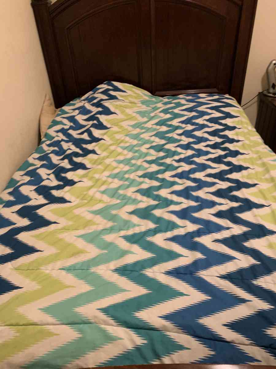 a couch a bed a dresser and a tv stand and a side table