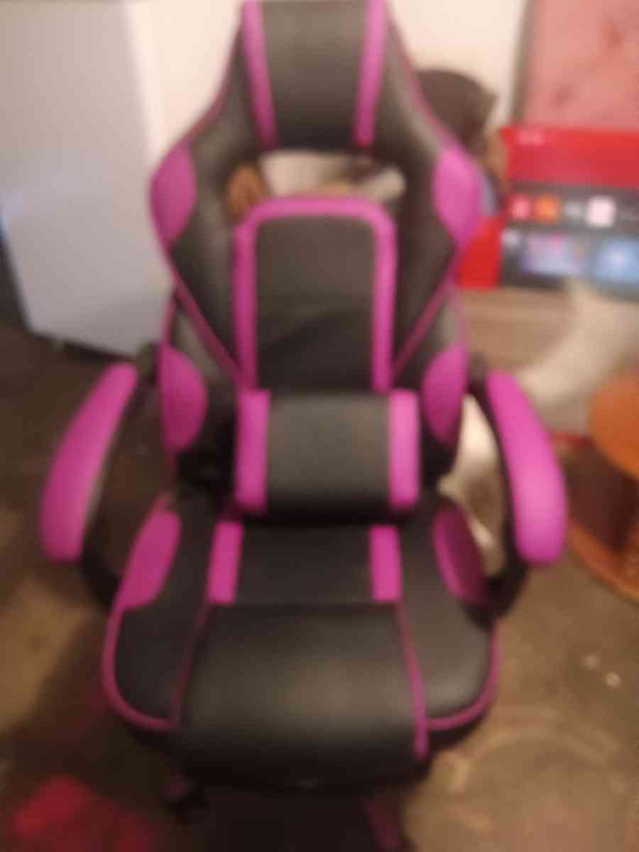 Pink and black gaming chair with vibrating pillow