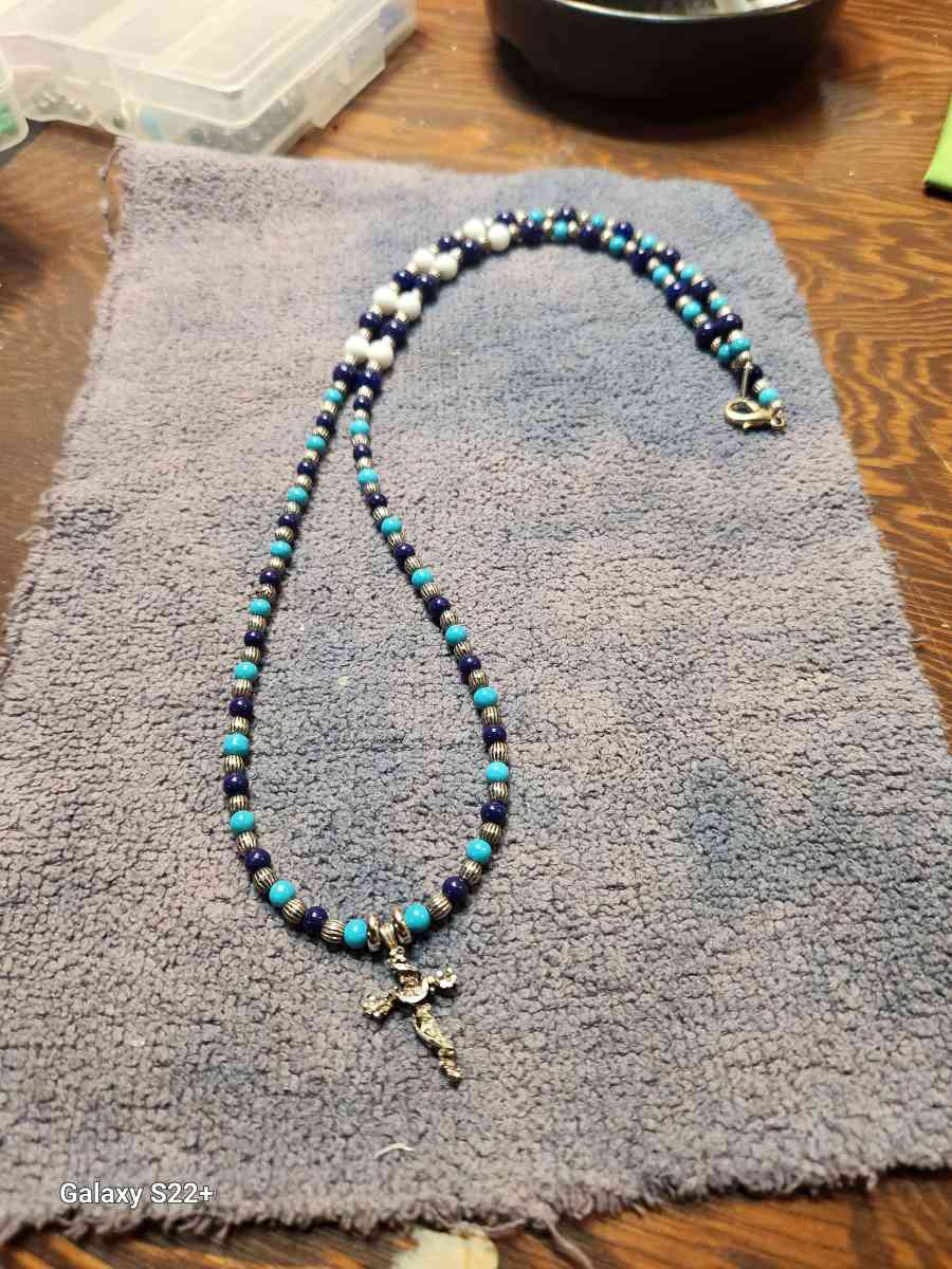 silver cross with glass bead necklace