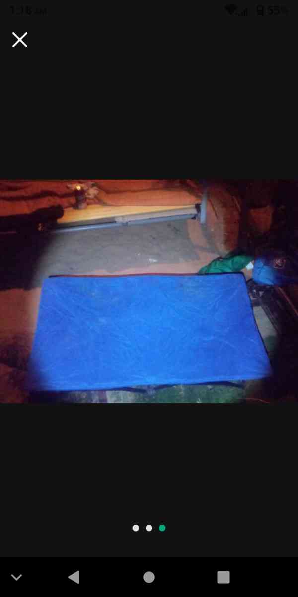 two foldable chairs with cup holders and one foldable cot