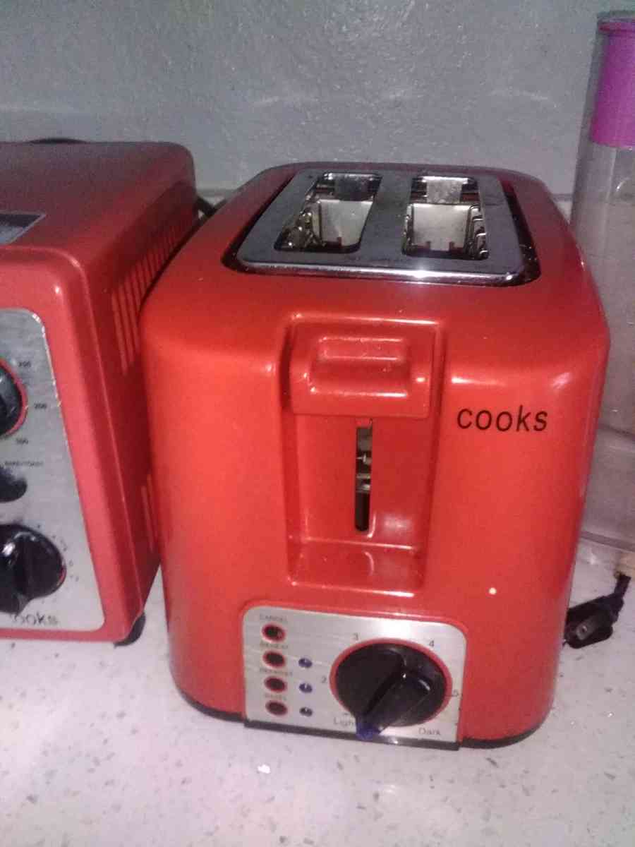 a red conventional oven with toaster from the brand Cooks