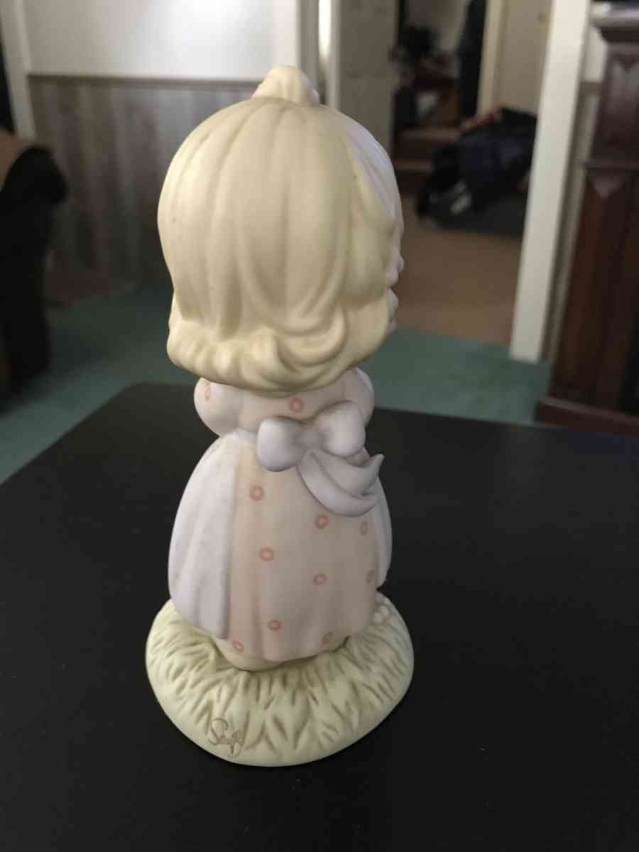 precious moment girl holding a cake