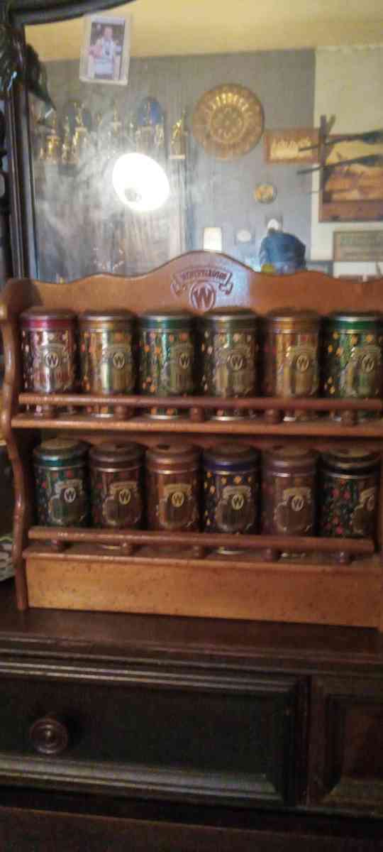 vintage spice cabinet with metal spice tins
