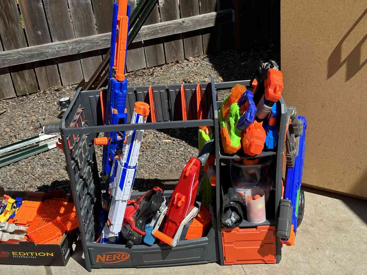Bunch of Nerf Guns Ammo Gear and a Nerf Shelf