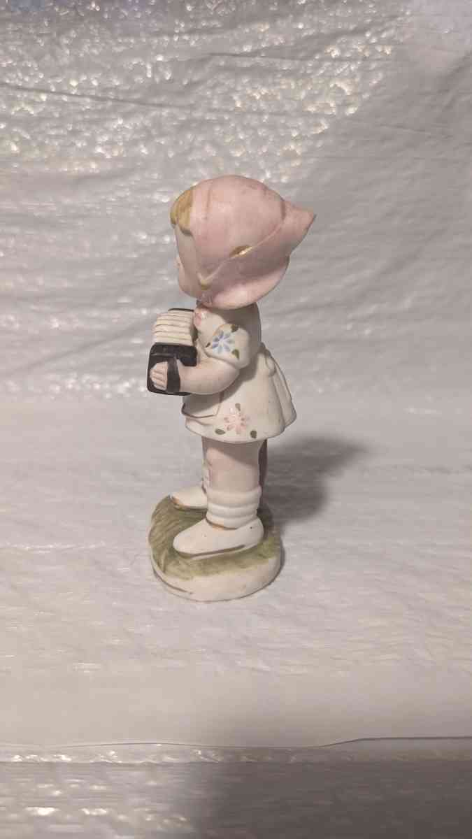 A Little Girl Playing an Accordion with a White Dress