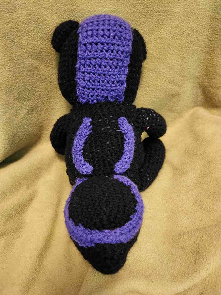 Spunky the black and purple Skunk