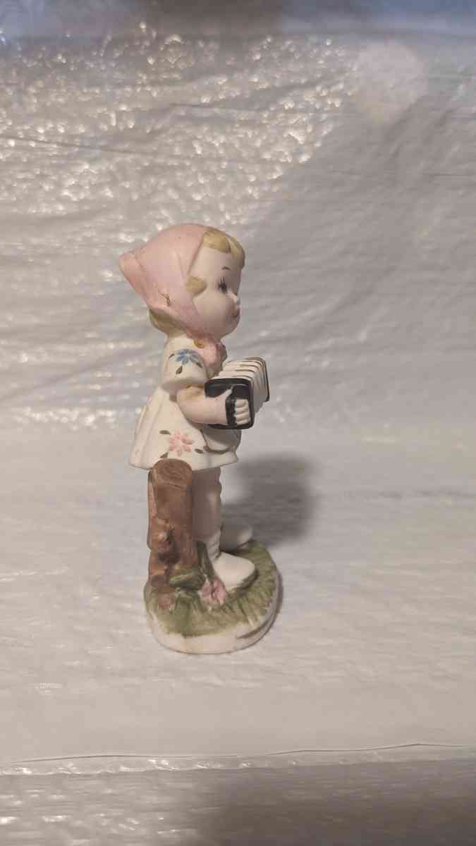 A Little Girl Playing an Accordion with a White Dress