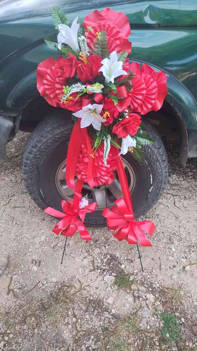 assorted flowers stands  virgin Mary pot