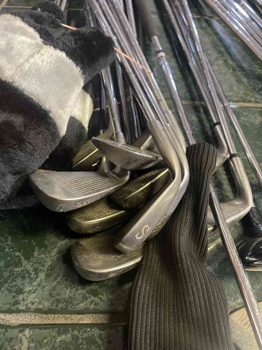 huge lot of golf clubs