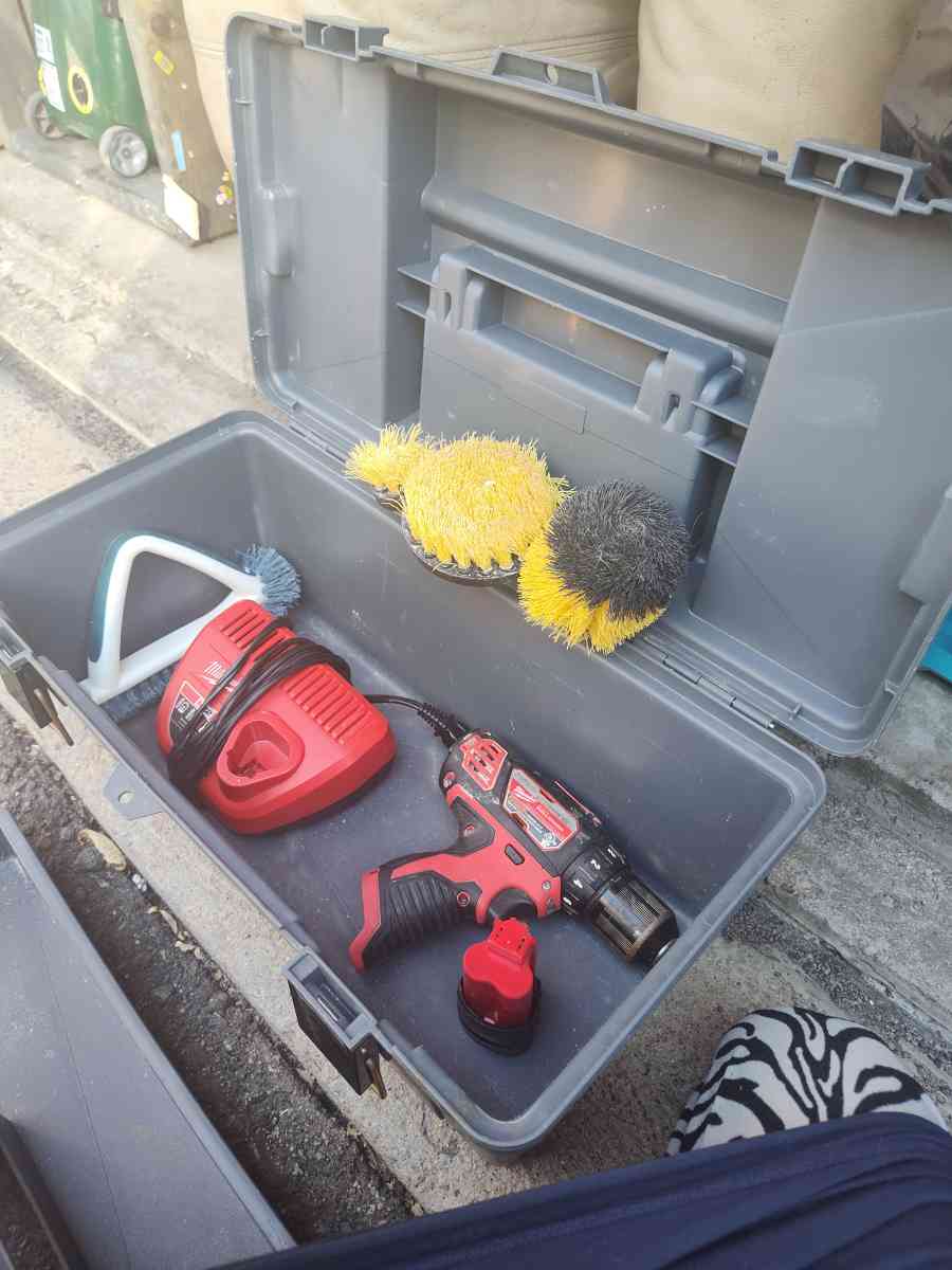 tool box with cleaning scrubbers and a drill