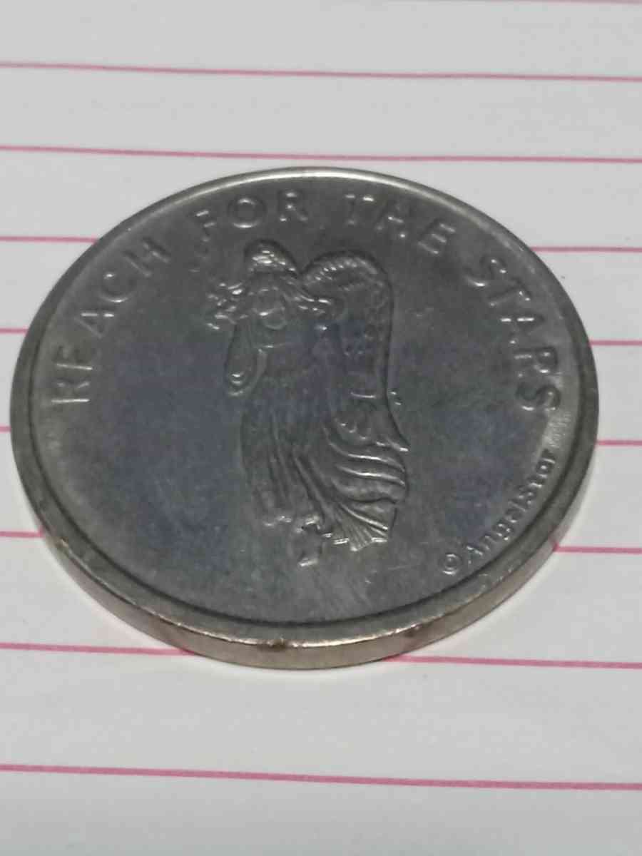 metal coin with  woman on it
