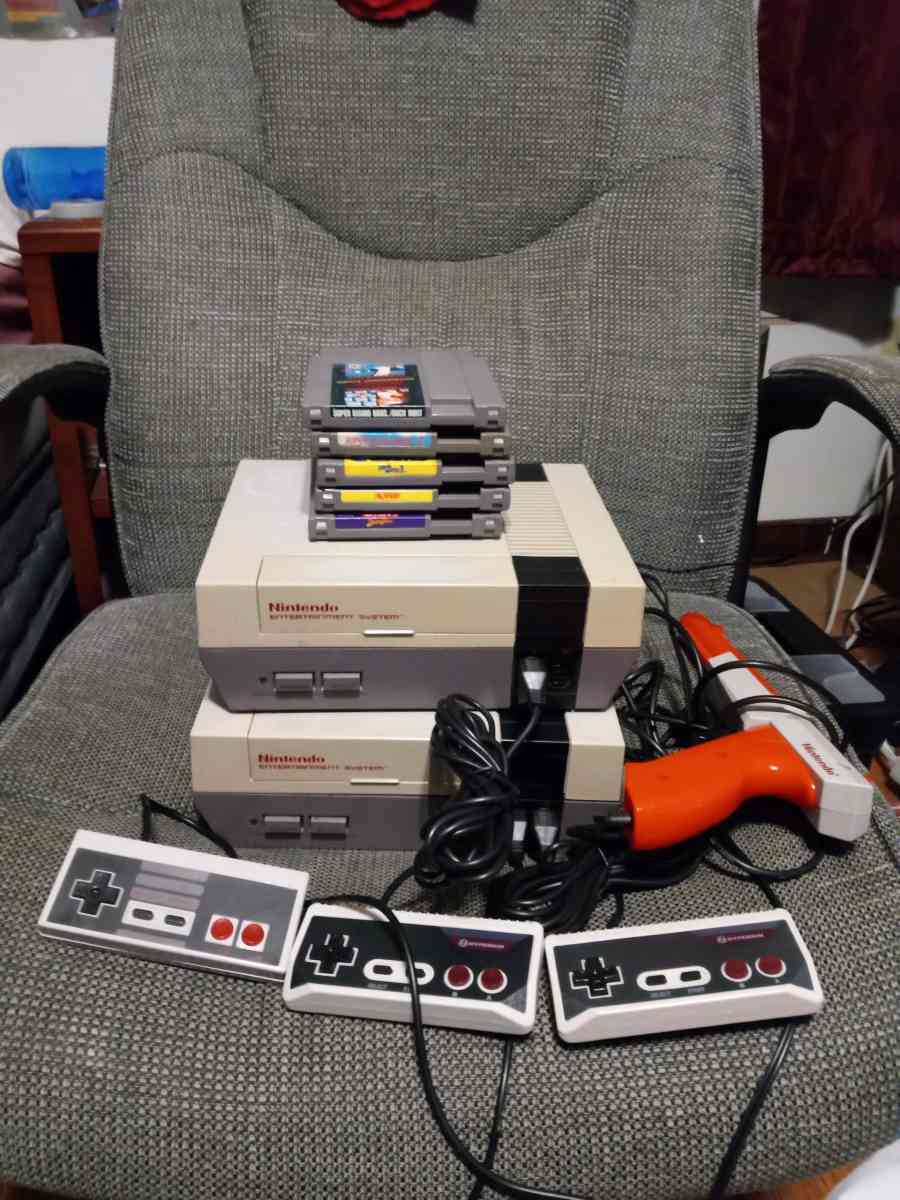 2 Nintendo NES consoles with 3 controllers and 5 games
