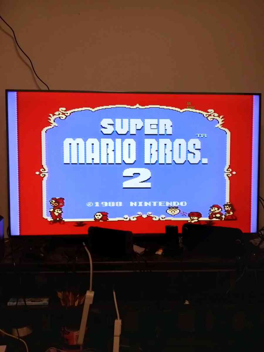 2 Nintendo NES consoles with 3 controllers and 5 games