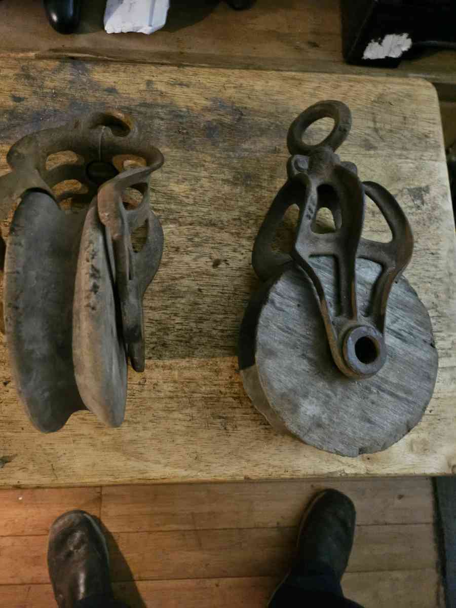 2 old wooden pulleys with metal frames 10 dollars for both