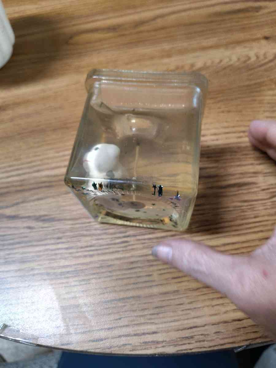 clear jelly candle with small white animals in the candle