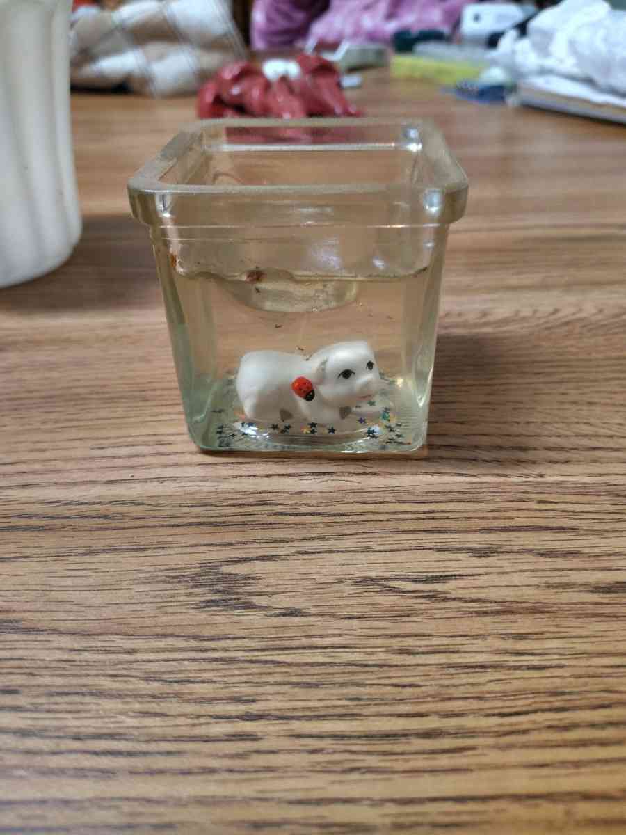 clear jelly candle with small white animals in the candle