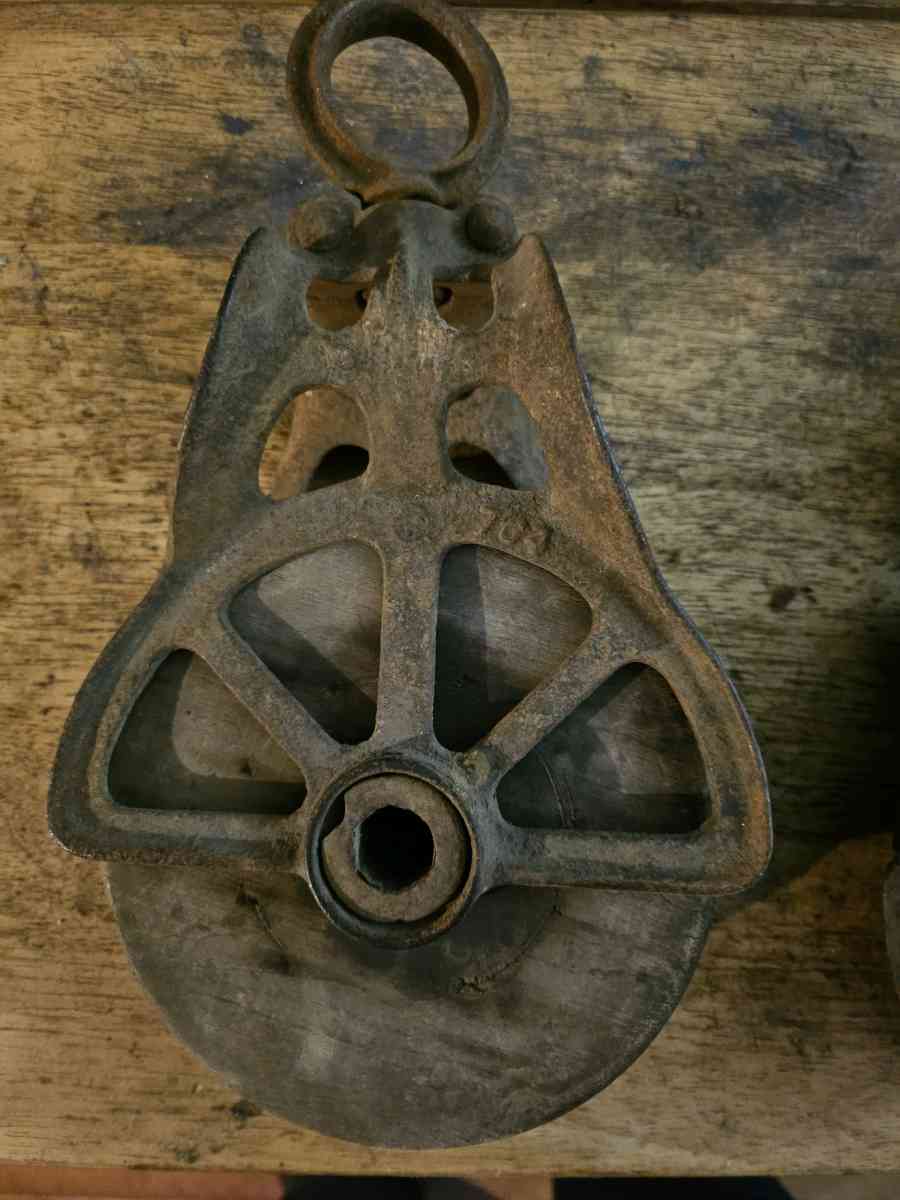 2 old wooden pulleys with metal frames 10 dollars for both