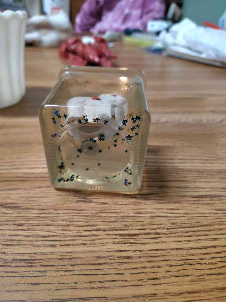 clear jelly candle with small white animals in the candle